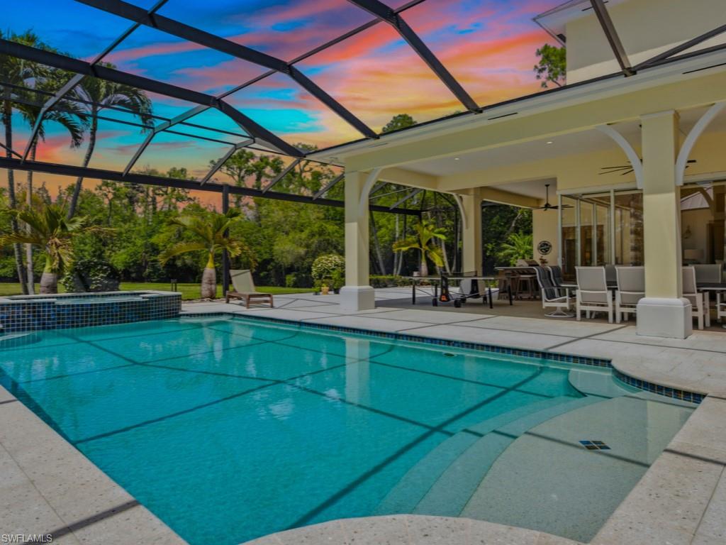 7051 Hunters Road Naples, FL 34109 - Photo 39 of 49 a view of a swimming pool with a patio