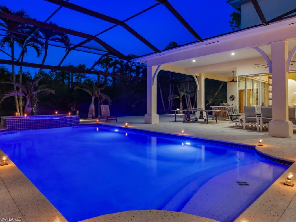 7051 Hunters Road Naples, FL 34109 - Photo 40 of 49 a view of swimming pool with outdoor seating