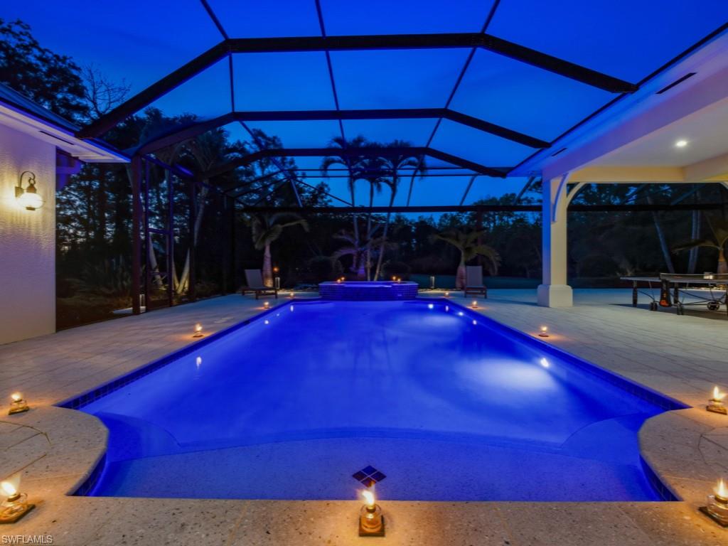 7051 Hunters Road Naples, FL 34109 - Photo 41 of 49 a view of a red chairs under an umbrella