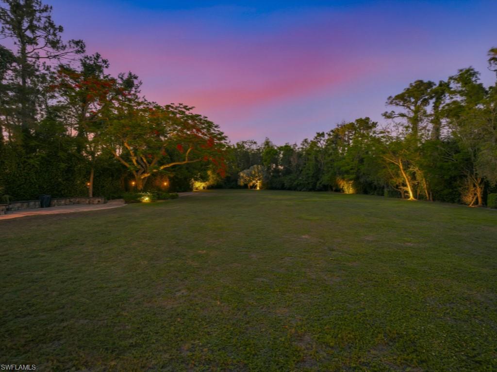 7051 Hunters Road Naples, FL 34109 - Photo 45 of 49 a view of a field of grass and trees
