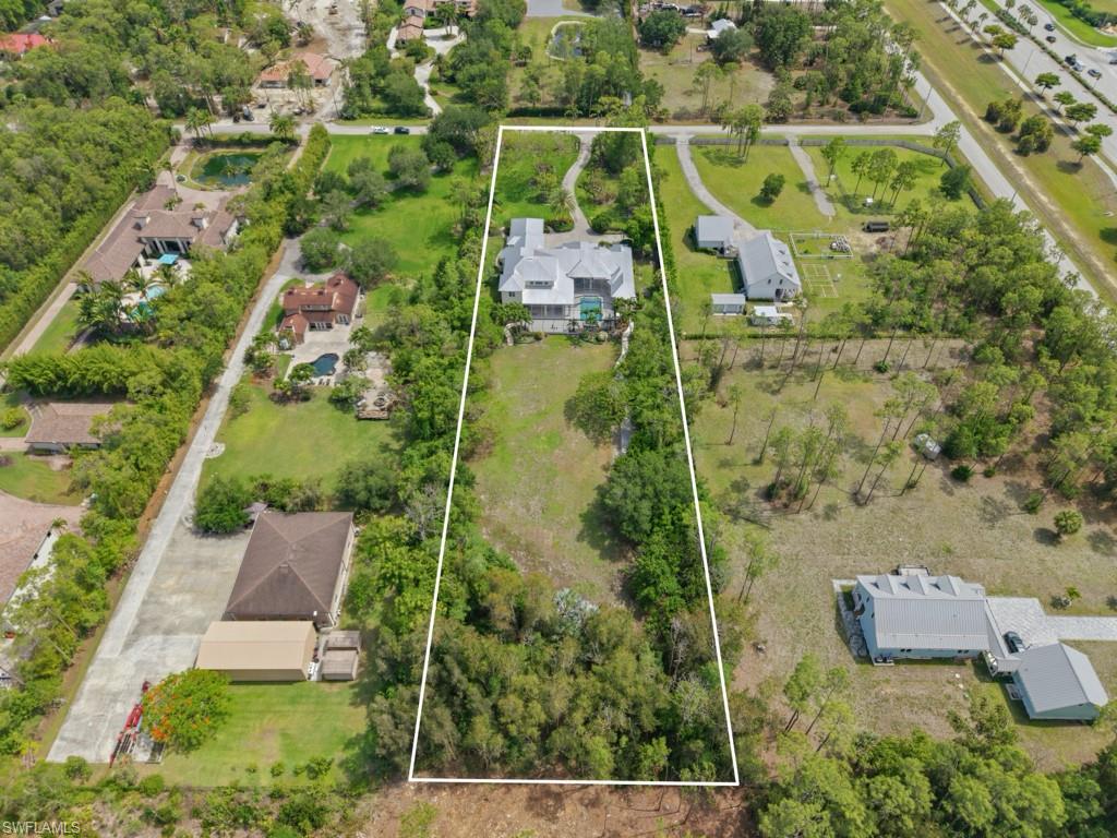 7051 Hunters Road Naples, FL 34109 - Photo 46 of 49 an aerial view of a house with a yard and lake view