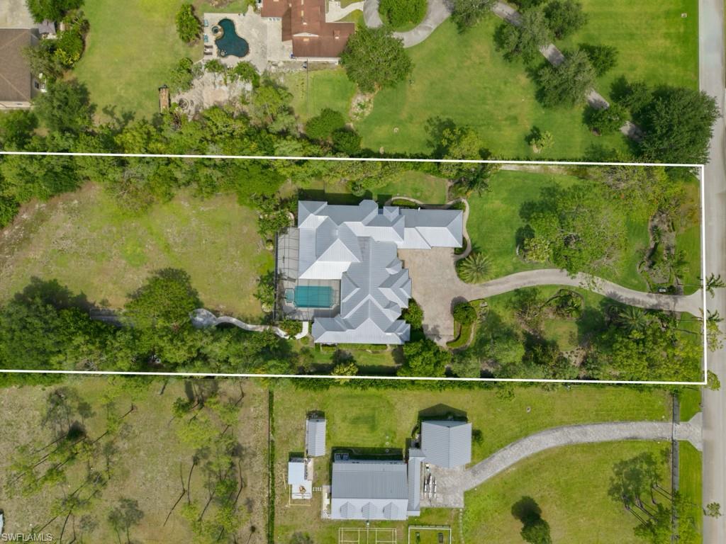 7051 Hunters Road Naples, FL 34109 - Photo 47 of 49 an aerial view of a house with a lake view