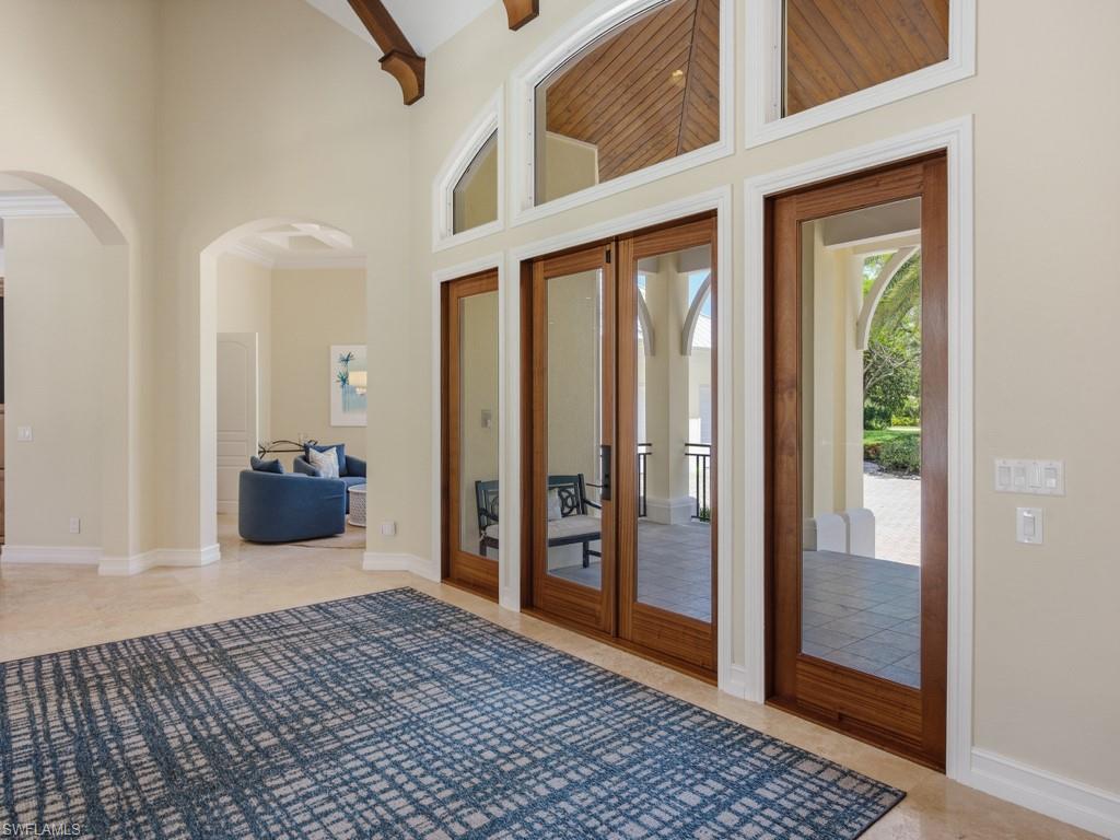 7051 Hunters Road Naples, FL 34109 - Photo 7 of 49 a view of a livingroom with wooden floor and windows