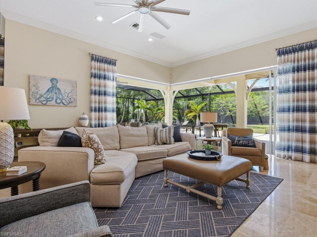 7051 Hunters Road Naples, FL 34109 - Photo 9 of 49 a living room with furniture and a large window