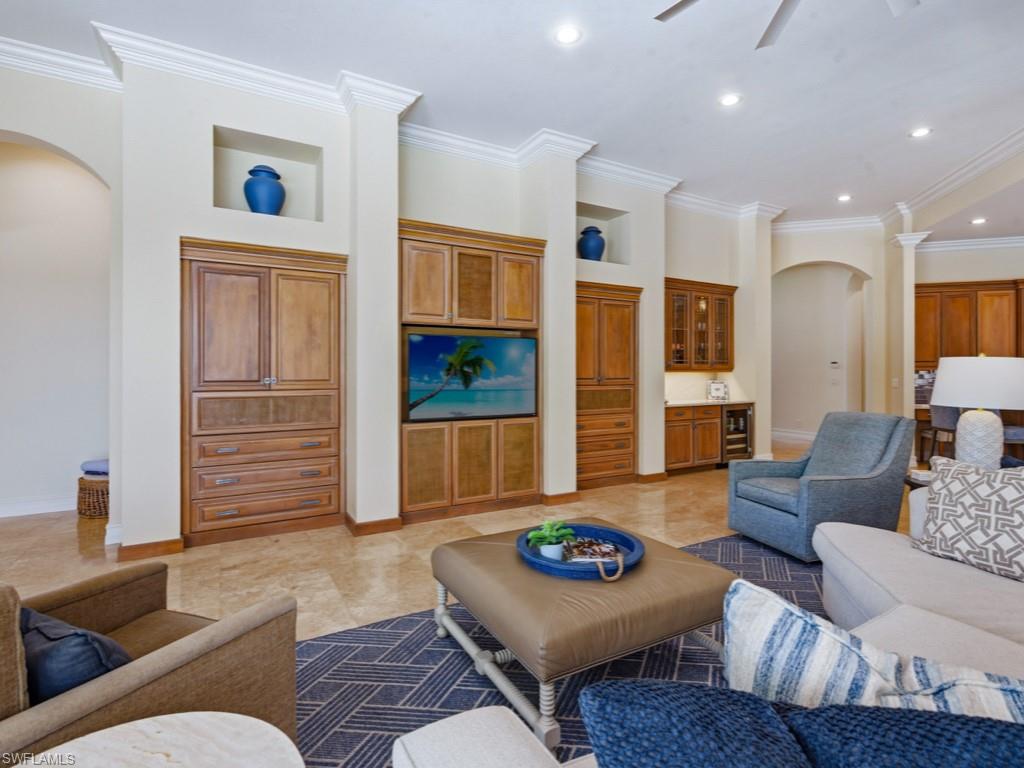 7051 Hunters Road Naples, FL 34109 - Photo 10 of 49 a living room with furniture and wooden floor