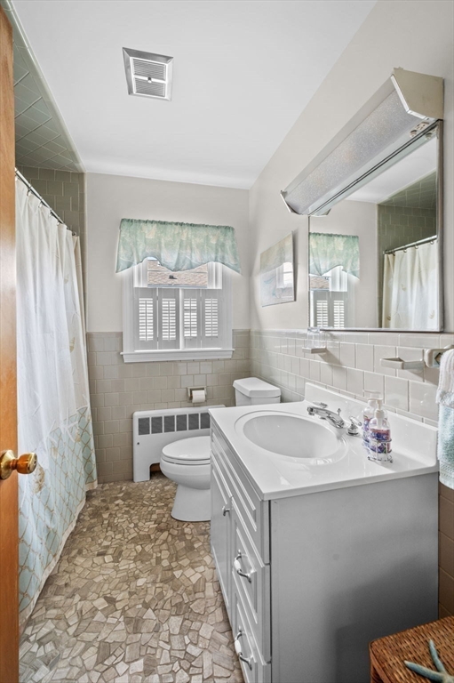 19-21 Cleveland Road Marblehead, MA 01945 - Photo 15 of 35 a bathroom with a sink a toilet and a mirror