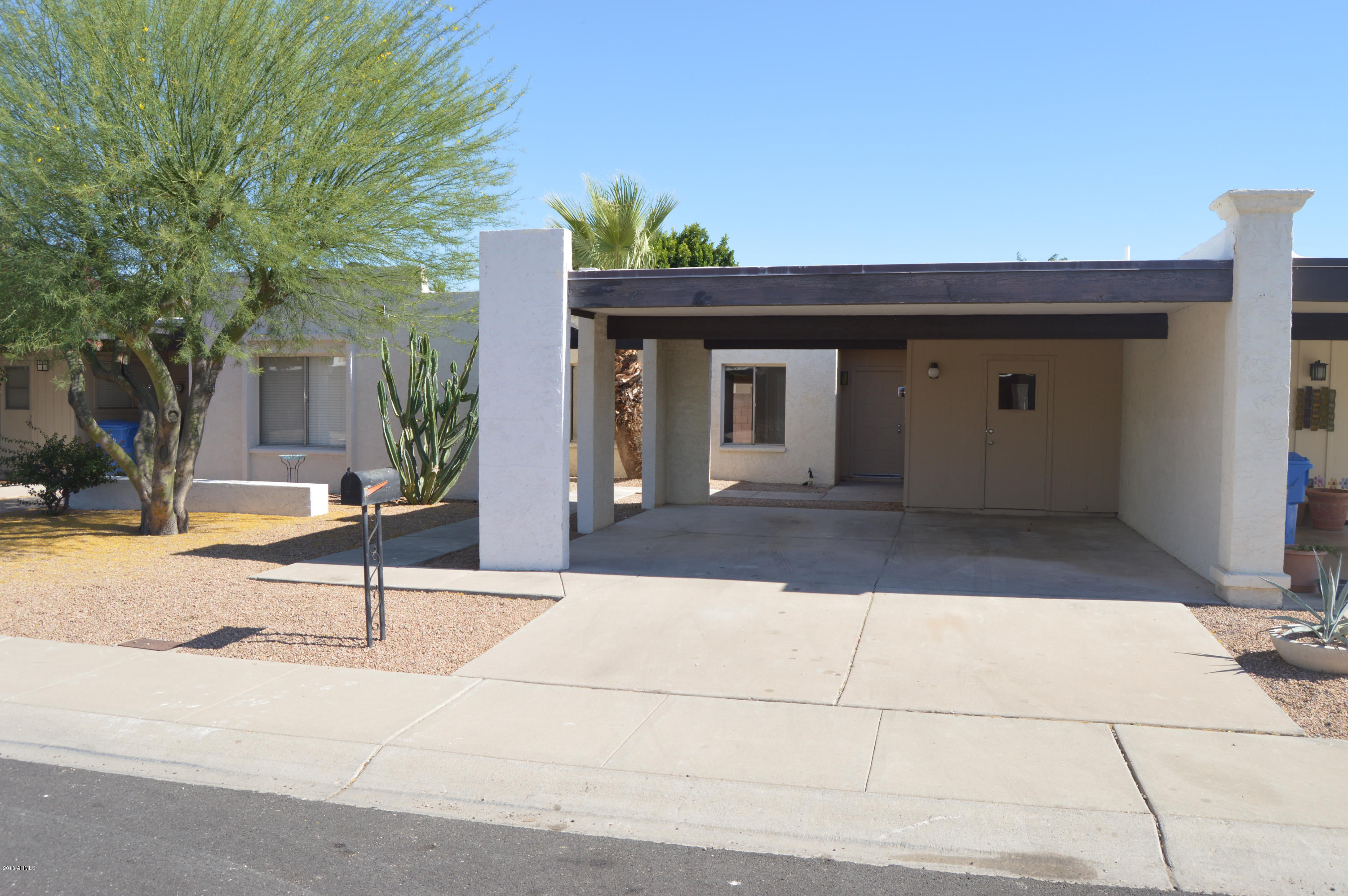 3029 West Redfield Road Phoenix, AZ 85053 - Photo 1 of 21 a view of a brick house with potted plants