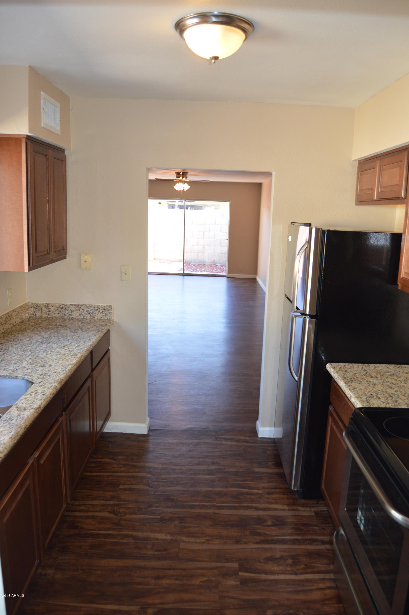 3029 West Redfield Road Phoenix, AZ 85053 - Photo 6 of 21 a kitchen with granite countertop a refrigerator and a stove