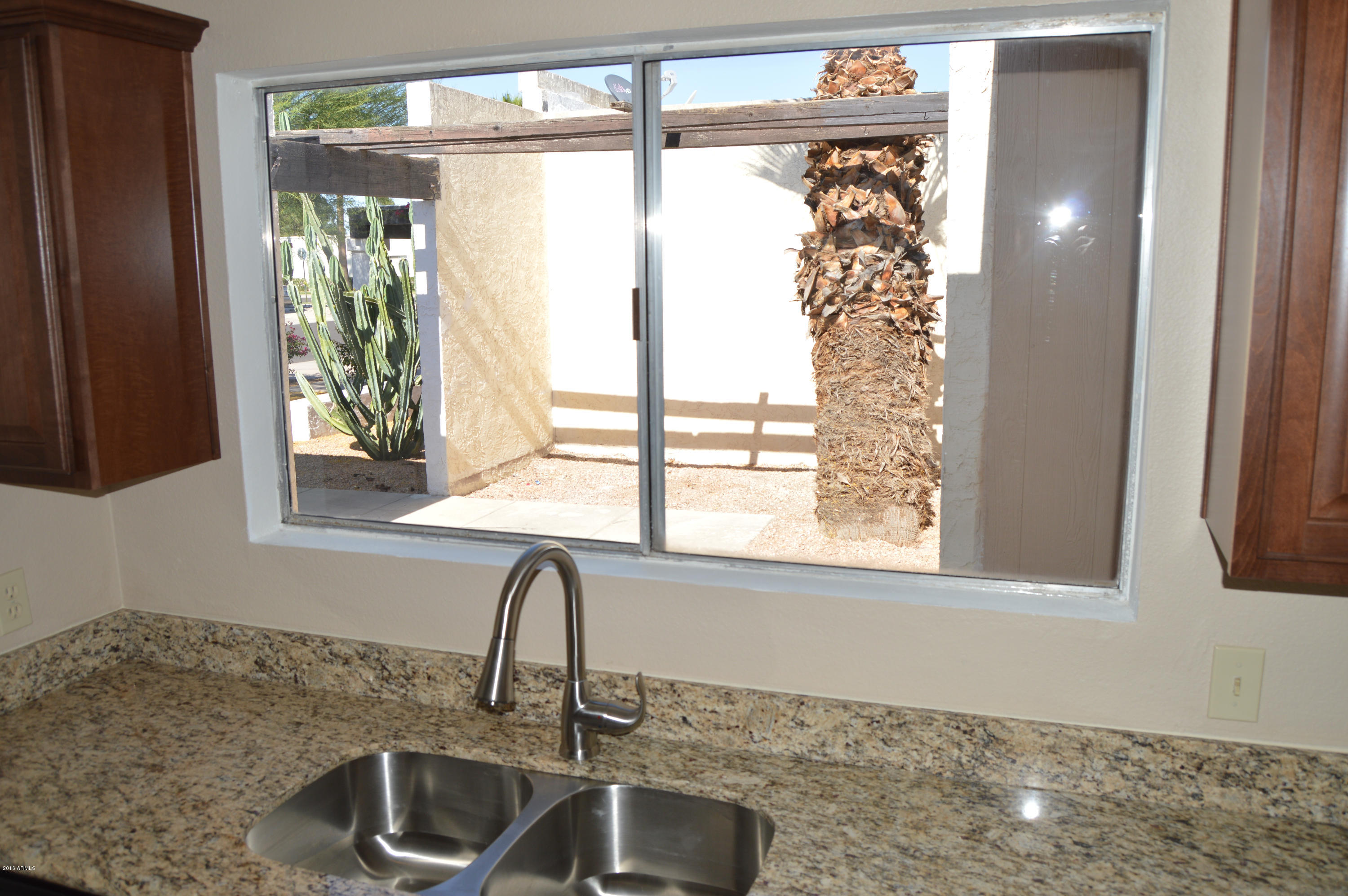 3029 West Redfield Road Phoenix, AZ 85053 - Photo 9 of 21 a kitchen with a sink and large window