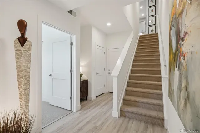 a view of entryway and hall with wooden floor