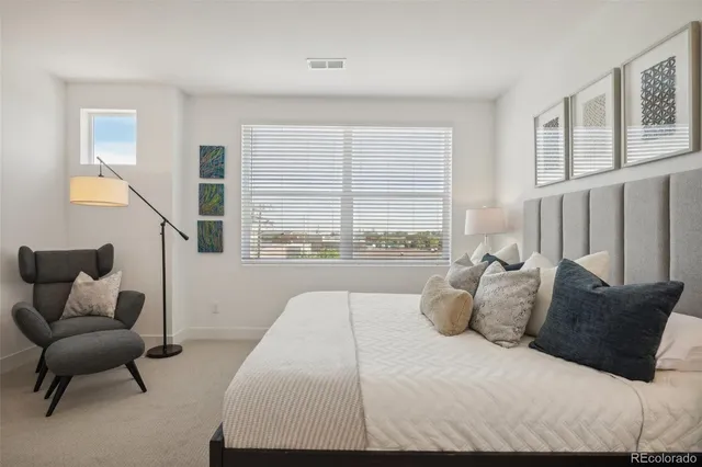 a bedroom with a bed and a couch