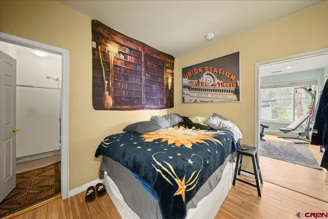 a bed sitting in a bedroom next to a window