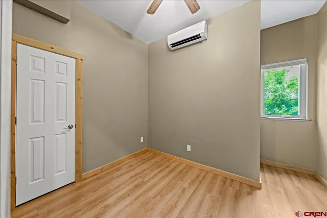 an empty room with closet and wooden floor
