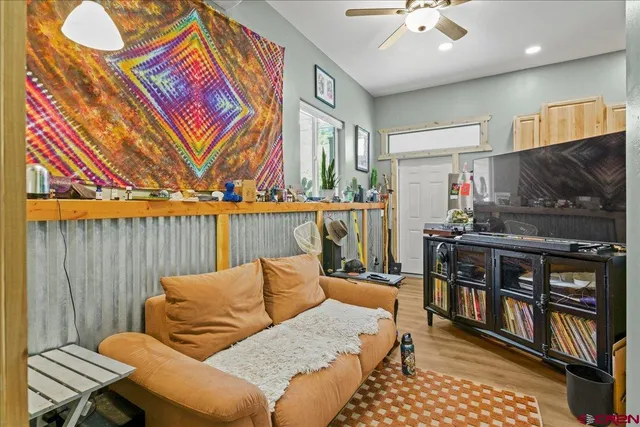 a living room with furniture a flat screen tv and a wall
