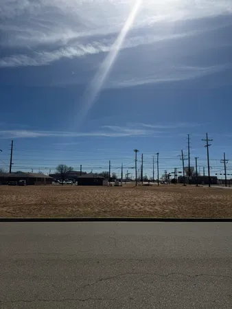 a view of a field with trees