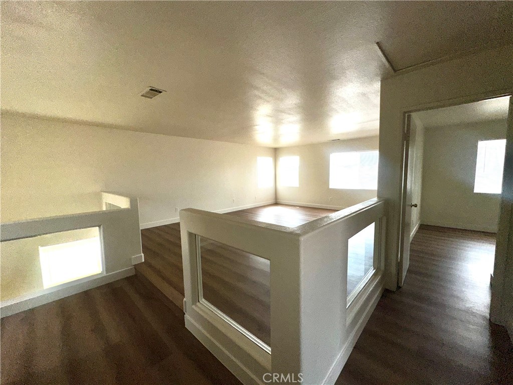 14413 Stivers Road Victorville, CA 92394 - Photo 11 of 17 a view of kitchen and hall with wooden floor