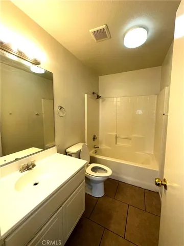 a bathroom with a sink mirror toilet and bathtub
