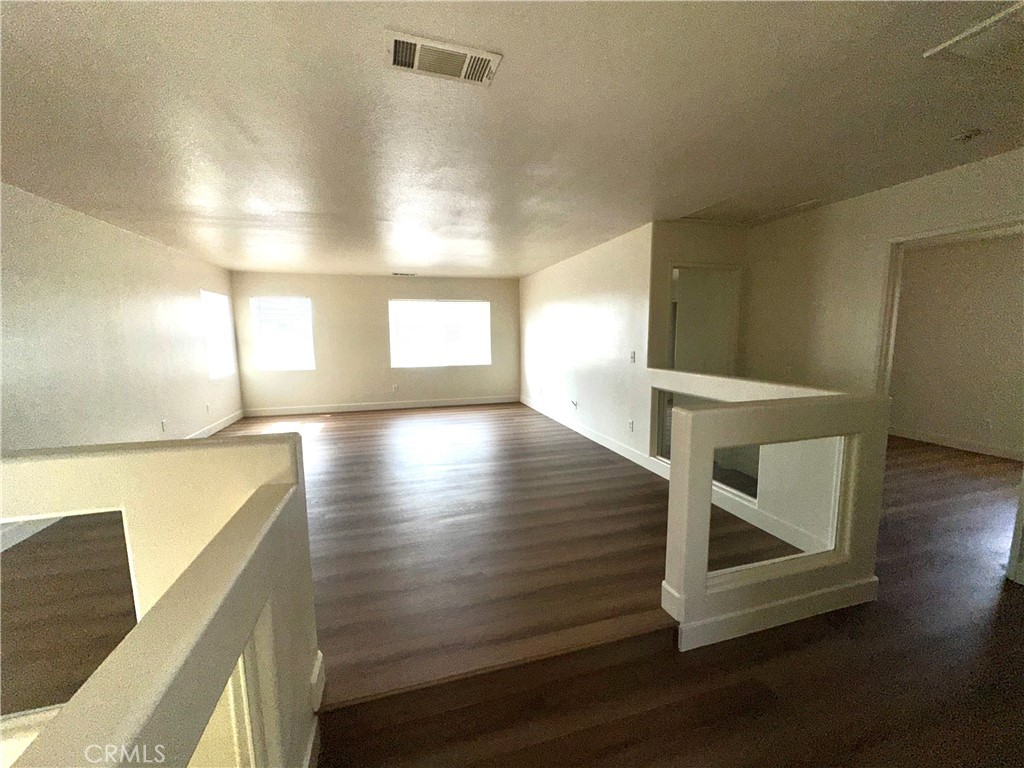 14413 Stivers Road Victorville, CA 92394 - Photo 9 of 17 a view of entryway and hall with wooden floor