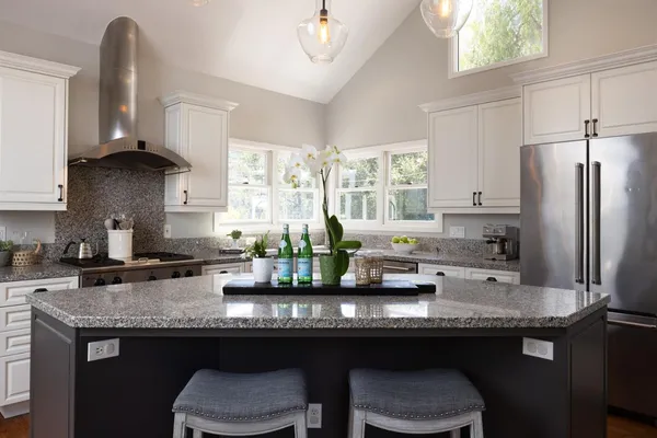 a kitchen with granite countertop a sink cabinets and window