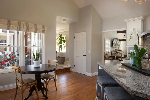 a dining room with furniture and wooden floor