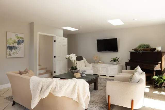 a bedroom with furniture and a flat screen tv