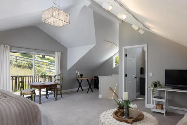 a living room with furniture a chandelier and a flat screen tv