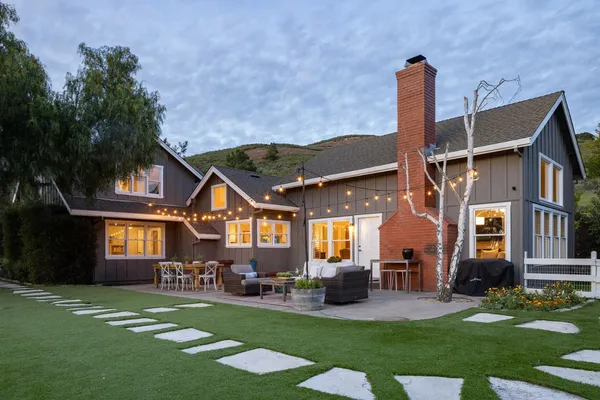 a front view of a house with a garden and patio