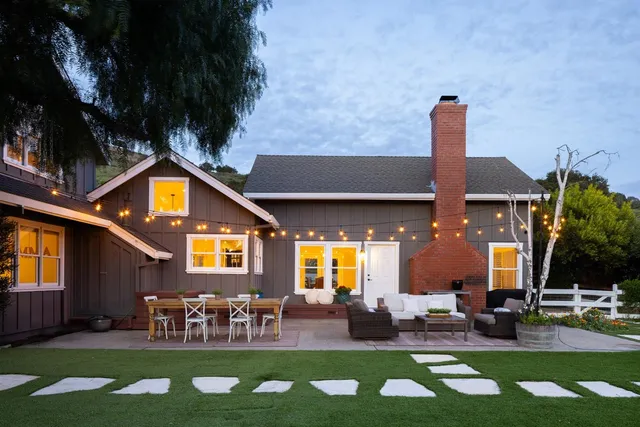 a front view of house with yard outdoor seating and outdoor seating