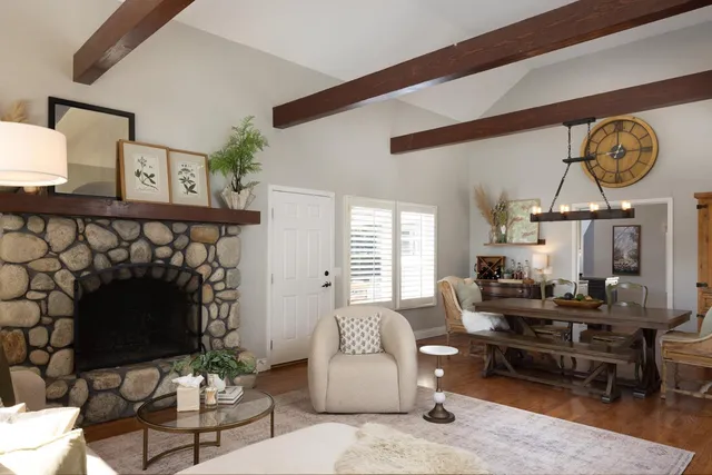 a living room with furniture a rug and a fireplace
