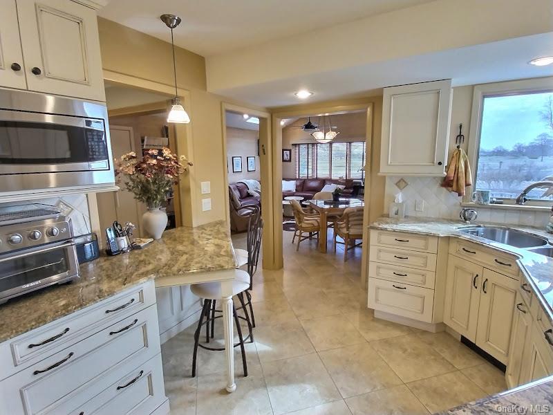 3421 Turf Road Oceanside, NY 11572 - Photo 31 of 50 a kitchen with white cabinets and appliances