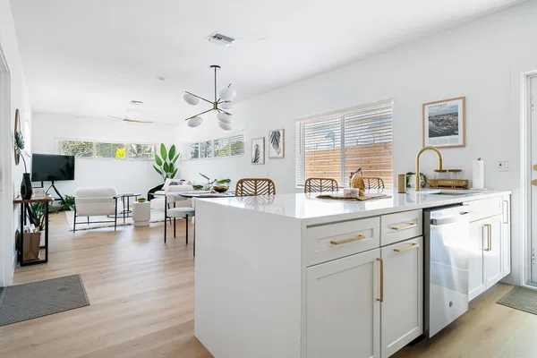 a living room with furniture and view of kitchen
