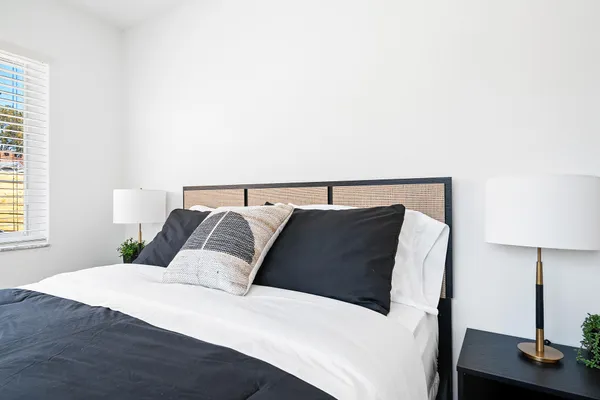 a bedroom with a bed and a lamp