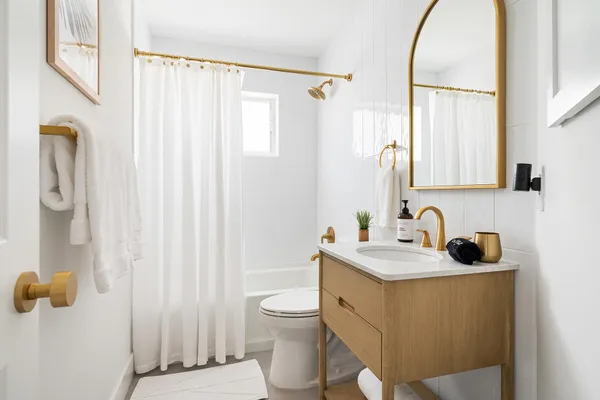 a bathroom with a sink toilet and shower
