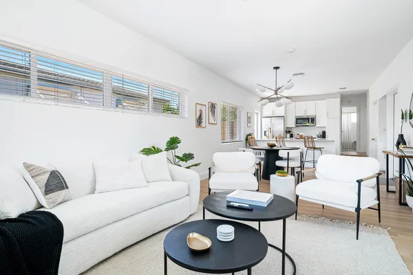 a living room with furniture and a dining table