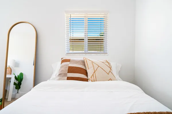 a bedroom with a bed and a window