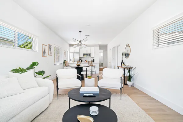 a living room with fireplace furniture and a rug
