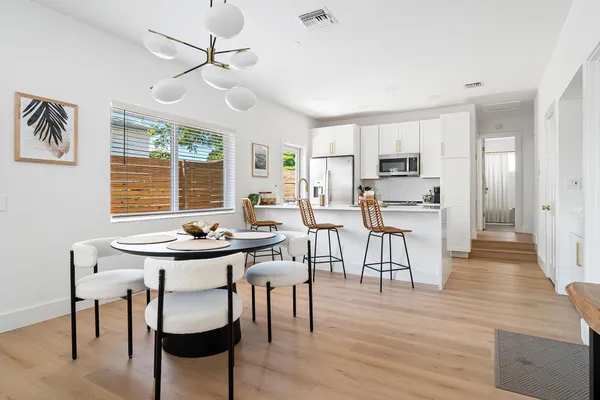 a view of a dining room with furniture window and wooden floor