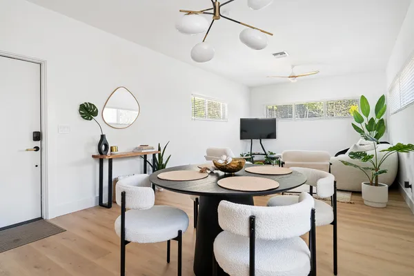 a view of a dining room with furniture and wooden floor
