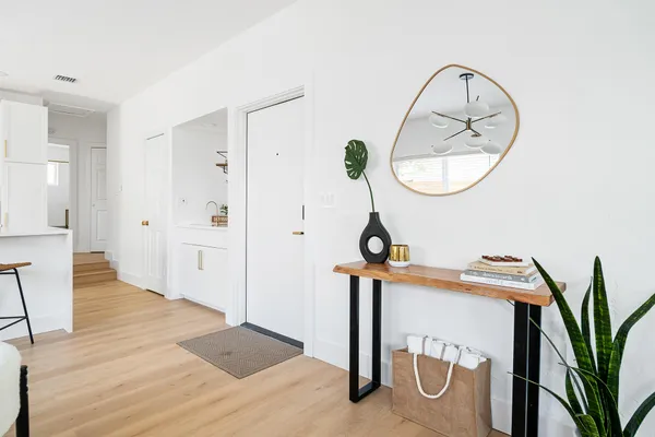 a view of a room with wooden floor and white walls