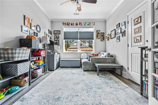 a children room with furniture and a book shelf