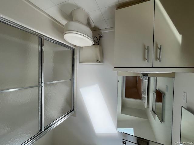 25 South Norwood Road, Unit LEFT Port Washington, NY 11050 - Photo 12 of 19 a white toilet sitting next to a bathroom sink