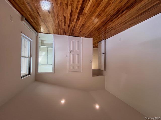 25 South Norwood Road, Unit LEFT Port Washington, NY 11050 - Photo 14 of 19 wooden floor in an empty room with a window
