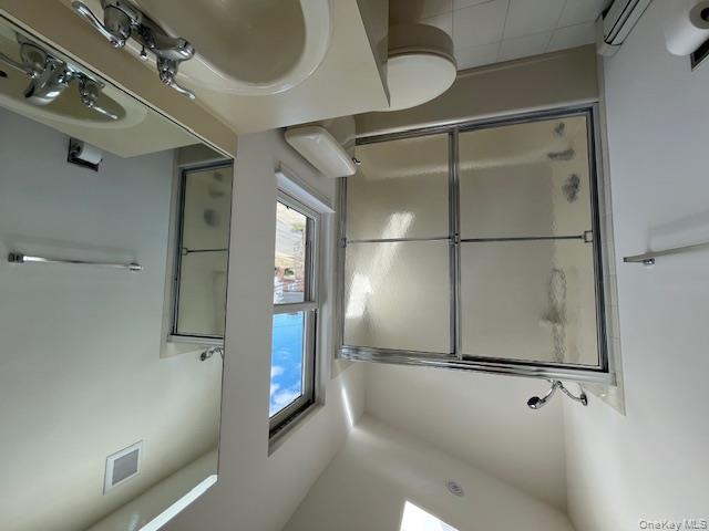25 South Norwood Road, Unit LEFT Port Washington, NY 11050 - Photo 15 of 19 a bathroom with a sink toilet and shower