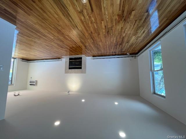 25 South Norwood Road, Unit LEFT Port Washington, NY 11050 - Photo 2 of 19 a view of an empty room with wooden floor and a window