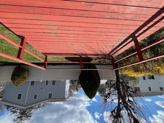 25 South Norwood Road, Unit LEFT Port Washington, NY 11050 - Photo 4 of 19 a view of outdoor space with wooden floor and a potted plant