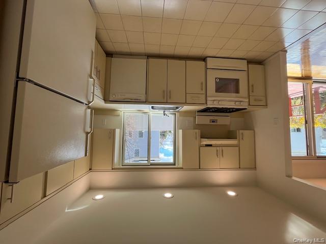 25 South Norwood Road, Unit LEFT Port Washington, NY 11050 - Photo 6 of 19 a kitchen with a refrigerator and a sink