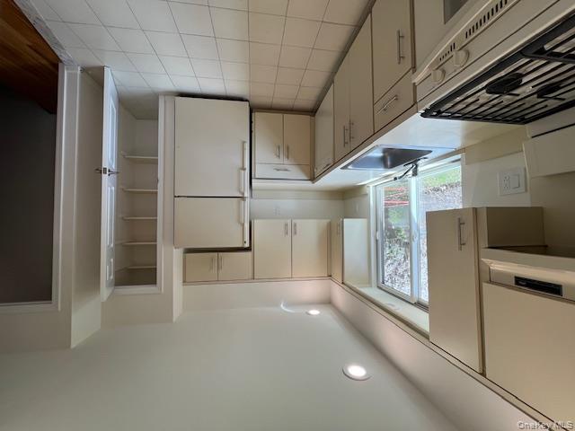 25 South Norwood Road, Unit LEFT Port Washington, NY 11050 - Photo 7 of 19 a kitchen with a sink a refrigerator and cabinets