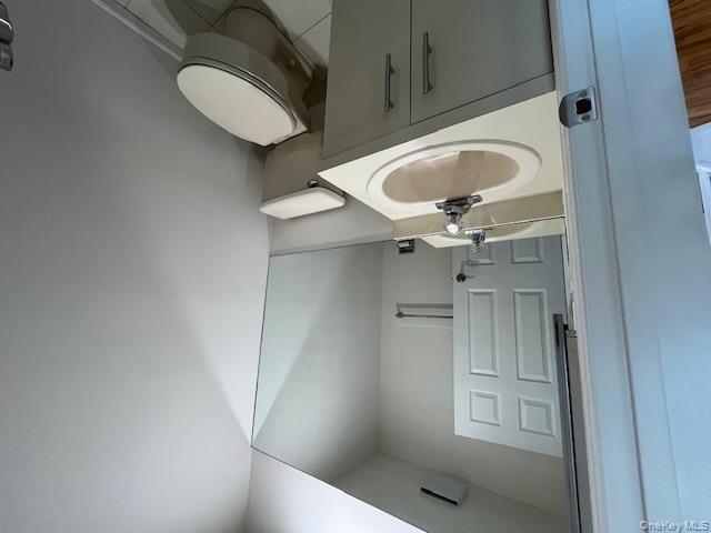 25 South Norwood Road, Unit LEFT Port Washington, NY 11050 - Photo 8 of 19 a bathroom with a sink toilet and mirror
