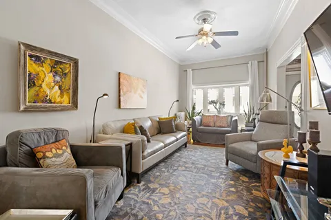 a living room with furniture ceiling fan and a rug
