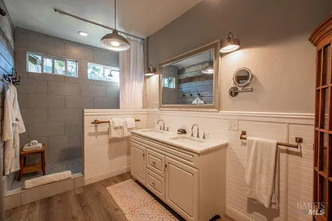 a bathroom with a sink a toilet and mirror